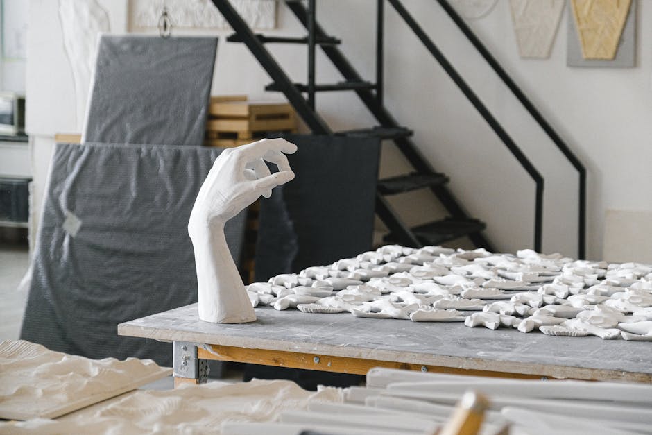 Art studio showcasing a table with handcrafted sculptures. Creative indoor space.